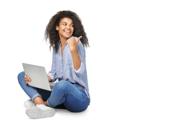 Portrait of a beautiful african woman with laptop isolated on white background